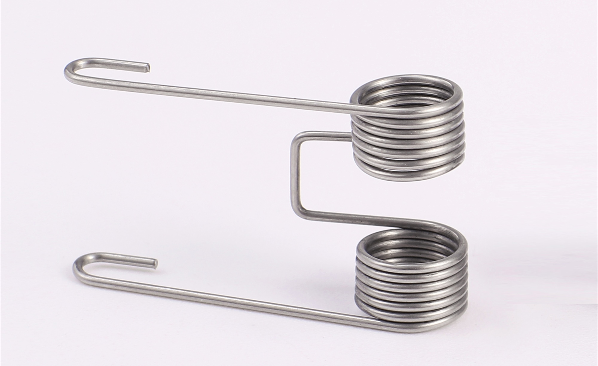 Coil extension, torsion spring manufacturing